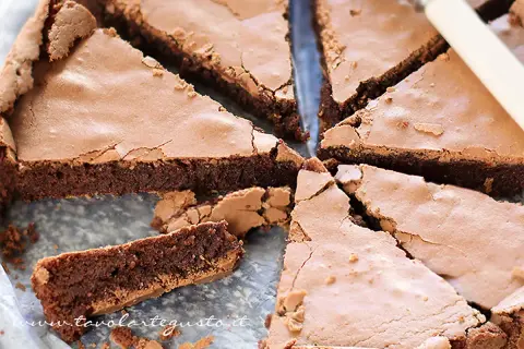 Fetta di torta tenerina, con la sua crosticina croccante e il cuore morbido e cioccolatoso, pronta per essere gustata.