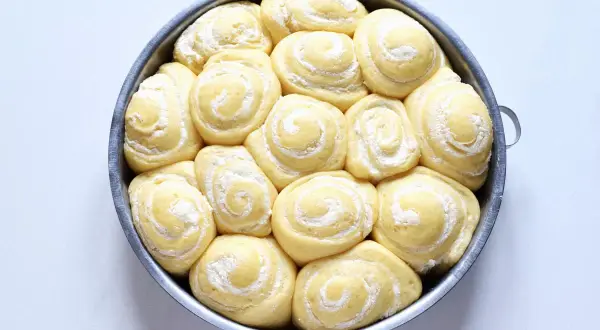 Torta di rose lievitata, soffice e dorata, pronta per essere infornata. Ogni rosellina è un invito alla dolcezza.