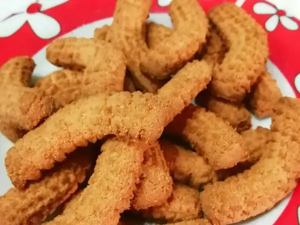 Un piatto pieno di krumiri fatti in casa, pronti per essere gustati. La ricetta perfetta per un dolce semplice e delizioso.